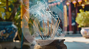 Incense sticks burning in a traditional pot with smoke, at a temple