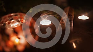 Incense Sticks And Candles Are Burning And Smoke On Dark Background. Smoke From Incense And Candle Light