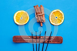 Incense sticks with citrus and cinnamon for fresh air on white background top view