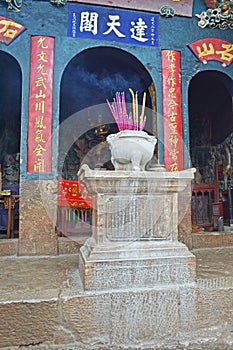 Incense sticks in the incense burner at the temple.