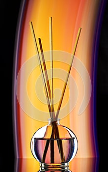 incense sticks in a jar of oil filmed with artificial decorative light