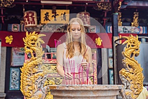 Incense sticks on joss stick pot are burning and smoke use for p