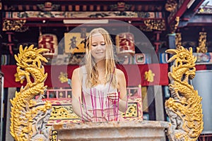 Incense sticks on joss stick pot are burning and smoke use for p