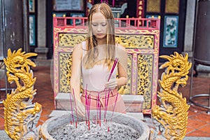 Incense sticks on joss stick pot are burning and smoke use for p