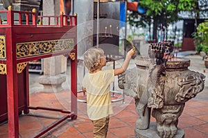 Incense sticks on joss stick pot are burning and smoke use for p