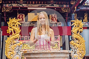 Incense sticks on joss stick pot are burning and smoke use for p