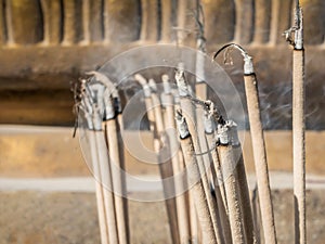 Incense sticks on joss stick pot are burning and smoke use for p