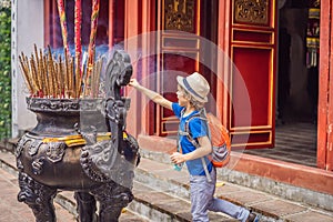 Incense sticks on joss stick pot are burning and smoke use for pay respect to the Buddha, Incense sticks in boy hand and