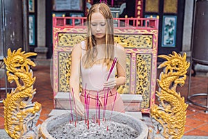 Incense sticks on joss stick pot are burning and smoke use for pay respect to the Buddha, Incense sticks in woman hand