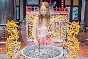 Incense sticks on joss stick pot are burning and smoke use for pay respect to the Buddha, Incense sticks in woman hand