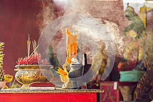 Incense sticks on joss stick pot are burning and smoke use for pay respect to the Buddha, respect to the Buddha in