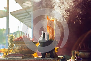 Incense sticks on joss stick pot are burning and smoke use for pay respect to the Buddha, respect to the Buddha in