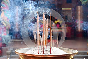 Incense sticks in the pot inside Chinese temple