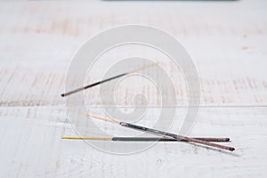 Incense on a white wooden background