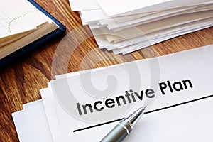 Incentive Plan and stack of papers.