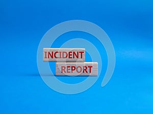 Incident Report symbol. Concept word Incident Report on wooden blocks. Beautiful blue background. Business and Incident Report