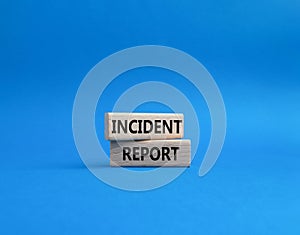 Incident Report symbol. Concept word Incident Report on wooden blocks. Beautiful blue background. Business and Incident Report