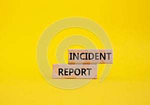 Incident Report symbol. Concept word Incident Report on wooden blocks. Beautiful yellow background. Business and Incident Report