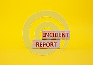 Incident Report symbol. Concept word Incident Report on wooden blocks. Beautiful yellow background. Business and Incident Report