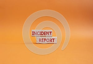 Incident Report symbol. Concept word Incident Report on wooden blocks. Beautiful orange background. Business and Incident Report