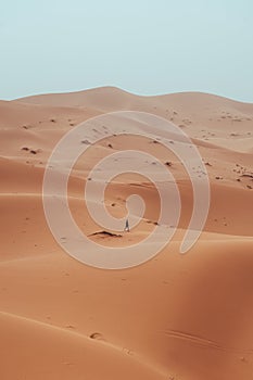 Incidental local berber man wandering through Sahara Desert Merzouga, Morocco