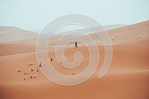 Incidental local berber man wandering through Sahara Desert Merzouga, Morocco