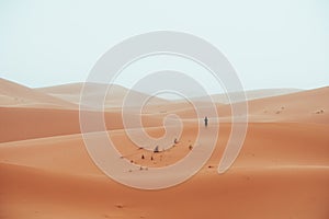 Incidental local berber man wandering through Sahara Desert Merzouga, Morocco