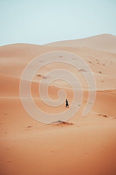 Incidental local berber man wandering through Sahara Desert Merzouga, Morocco