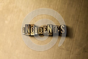 INCIDENTS - close-up of grungy vintage typeset word on metal backdrop photo