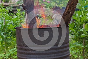 Incineration of garbage in a rusty metal barrel