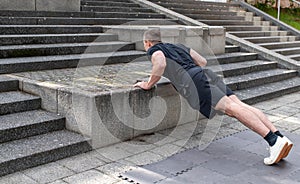 Incline push-up doing by a young athletic man. Push-up modification for beginners