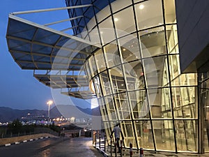 An Inclined Glass wall or Facade with aluminum framed for an high rise building entrance with Big Canopy as an exterior Finish in