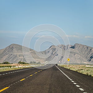 Inclined road to the right side with mountains to the horizon