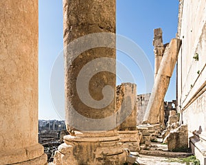 Inclined Roman column leaning against Temple of Bacchus wall, Heliopolis Roman ruins, Baalbek, Lebanon