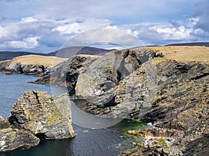Inclined strata in coastal rock at Kenna Ness, Shetland, UK.