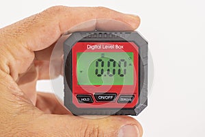 inclinometer, small safe level measuring device between fingers of a hand, 0Â°