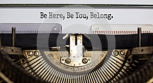 Inclusion and belonging symbol. Words `be here, be you, belong` typed on retro typewriter. Business, inclusion, belonging and yo photo