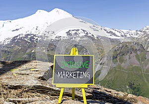 Inclusive marketing symbol. Concept words Inclusive marketing on beautiful black blackboard. Beautiful mountain Elbrus sky