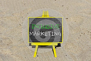 Inclusive marketing symbol. Concept words Inclusive marketing on beautiful black blackboard. Beautiful sand beach background.
