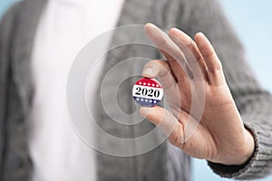 Incognito voter holding vote button on blue background