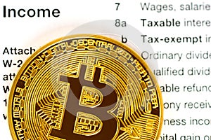 Income part of tax return 1040 form with metallic bitcoin coin