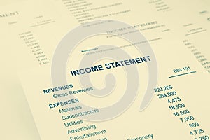 Income statement reports for business accounting in sepia tone