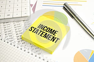 INCOME STATEMENT text on the yellow card on the chart background