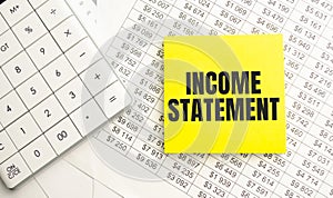 INCOME STATEMENT text on the yellow card on the chart background