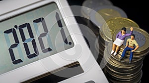 Income Tax Campaign 2021 Spain. Young Couple sitting on coin stack. Declaracion de la Renta. Macro photo