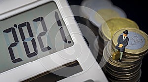 Income Tax Campaign 2021 Spain. Young Couple sitting on coin stack. Declaracion de la Renta. Macro photo