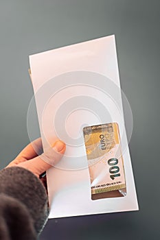 incomes in European countries. Envelope with money.salary in the envelope.pack of euro bills in an envelope on a gray