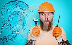 Incompetent worker plumber is unsure about his work. cyan background photo