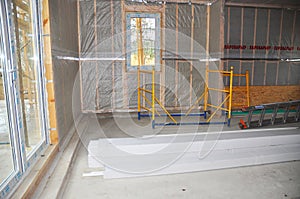 An incomplete frame house from structural insulated panels (SIPs) indoors with a vapour barrier