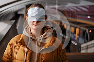 Incorrectly put on a mask on a woman in public transport among people